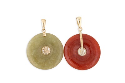 Lot 89 - TWO JADE DONUT PENDANTS, with 14ct gold mounts,...