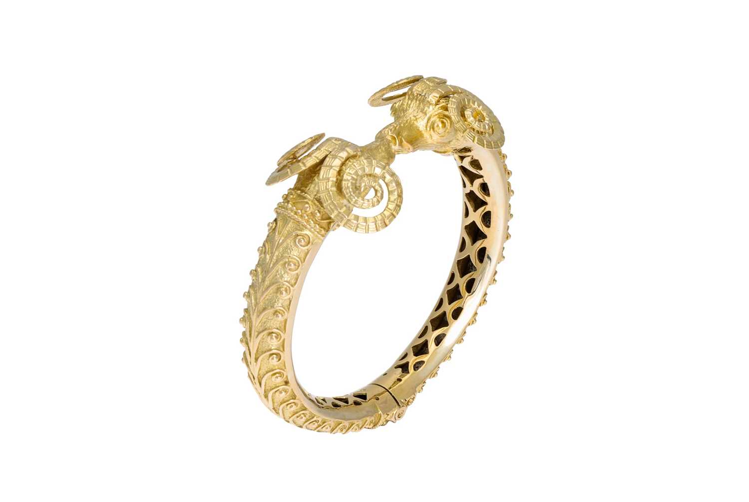 Lot 51 - AN 18CT GOLD HINGED BANGLE, modelled as twin...