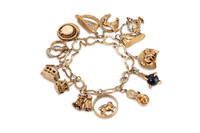 Lot 199 - A 9CT GOLD CHARM BRACELET, various charms...