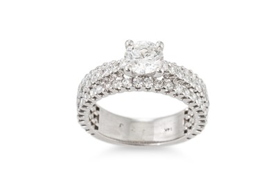 Lot 319 - A DIAMOND SOLITAIRE RING, to three rowed...