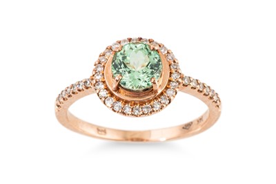 Lot 228 - A GREEN GARNET AND DIAMOND CLUSTER RING,...