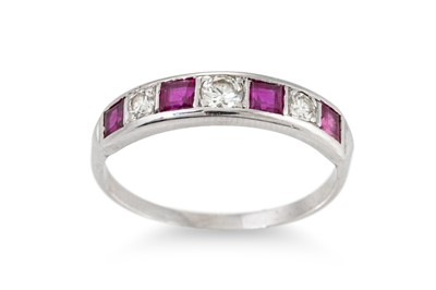 Lot 275 - A DIAMOND AND RUBY SEVEN STONE RING, mounted...