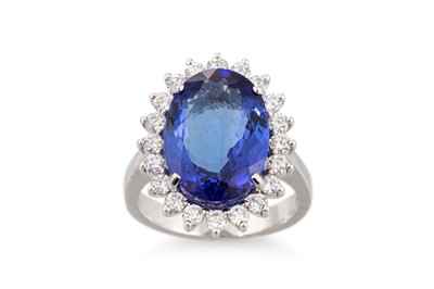 Lot 182 - A TANZANITE AND DIAMOND CLUSTER RING, the oval...