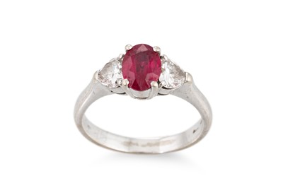 Lot 183 - A RUBY AND DIAMOND RING, the oval ruby to...
