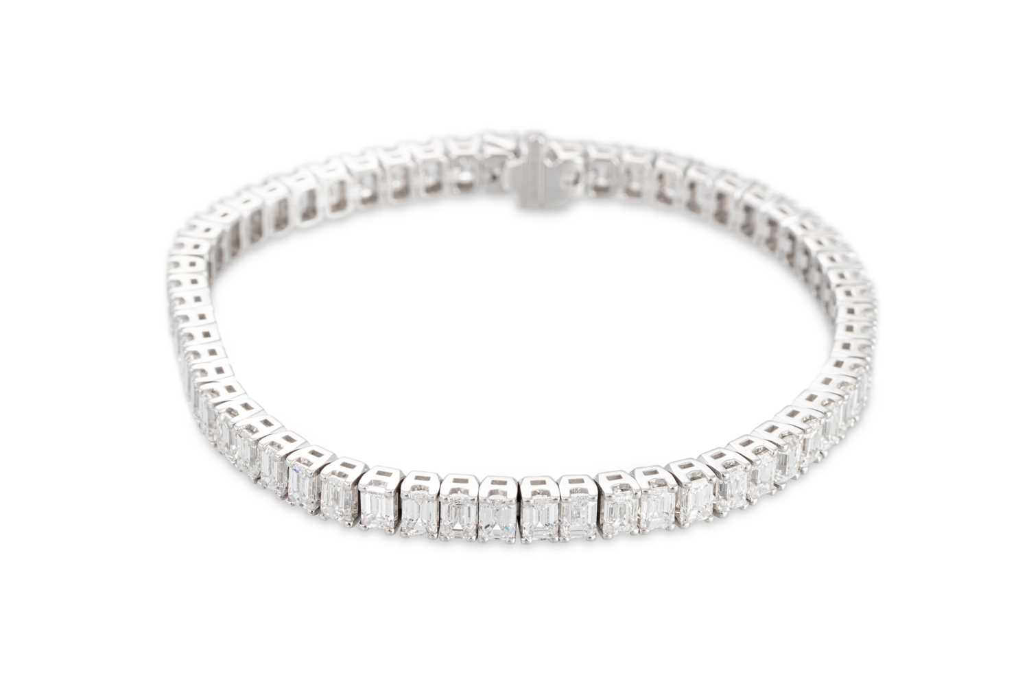 Lot 221 - AN IMPORTANT EMERALD CUT DIAMOND LINE BRACELET,...