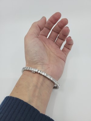 Lot 221 - AN IMPORTANT EMERALD CUT DIAMOND LINE BRACELET,...