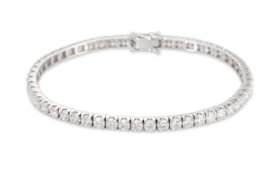 Lot 226 - A DIAMOND LINE BRACELET, the brilliant cut...
