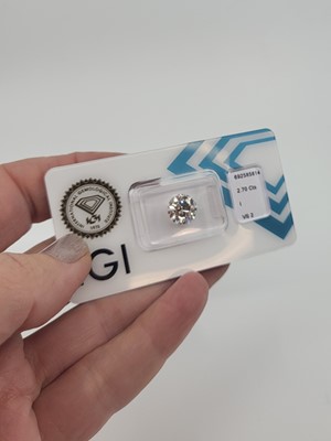 Lot 295 - AN UNMOUNTED BRILLIANT CUT DIAMOND, together...