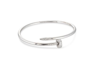 Lot 354 - A CARTIER JUSTE UN CLOU BANGLE, diamond set in...