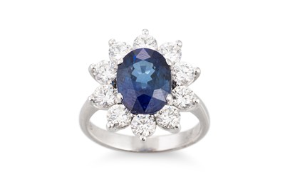 Lot 246 - A SAPPHIRE AND DIAMOND CLUSTER RING, the oval...