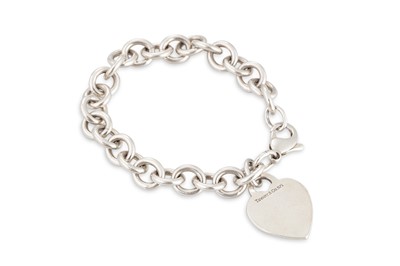 Lot 100 - A SILVER HEART CHARM BRACELET, stamped Tiffany...
