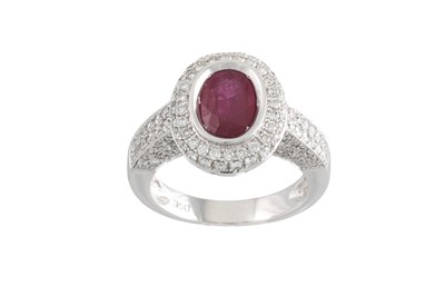 Lot 214 - A RUBY AND DIAMOND CLUSTER RING, the oval ruby...