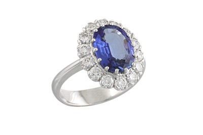 Lot 215 - A SAPPHIRE AND DIAMOND CLUSTER RING, the oval...