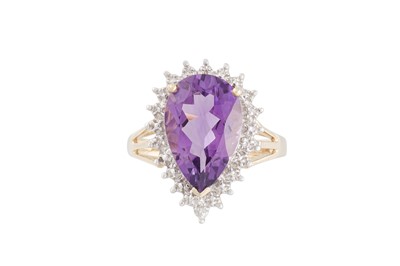 Lot 77 - A DIAMOND AND AMETHYST RING, the pear shaped...