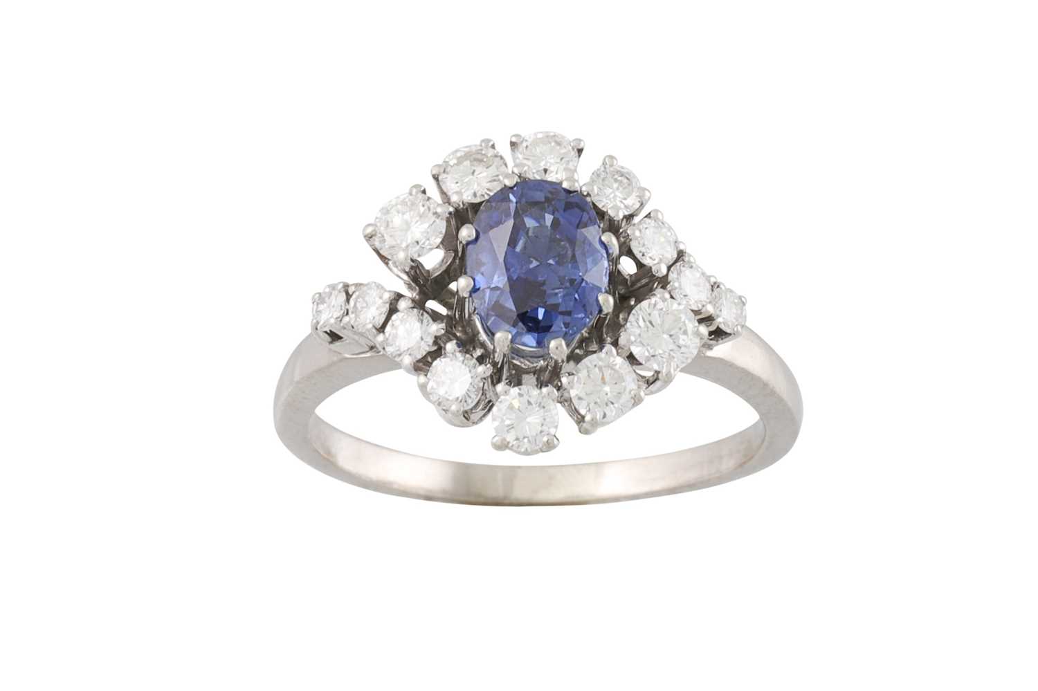 Lot 103 - A SAPPHIRE AND DIAMOND CLUSTER RING, the oval...