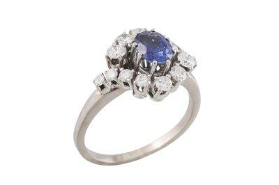 Lot 103 - A SAPPHIRE AND DIAMOND CLUSTER RING, the oval...