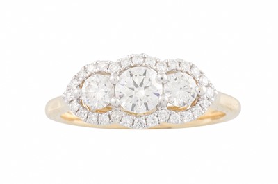 Lot 320 - A DIAMOND TRIPLE 'HALO' CLUSTER RING, set with...