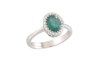 Lot 256 - AN EMERALD AND DIAMOND CLUSTER RING, oval form...