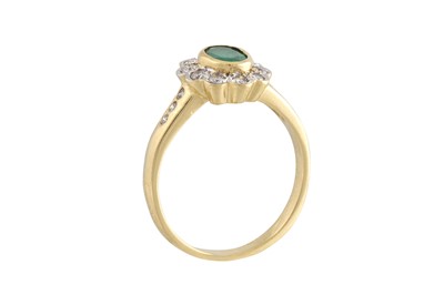 Lot 200 - AN EMERALD AND DIAMOND CLUSTER RING, of oval...