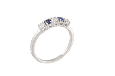 Lot 179 - A DIAMOND AND SAPPHIRE FIVE STONE RING, the...