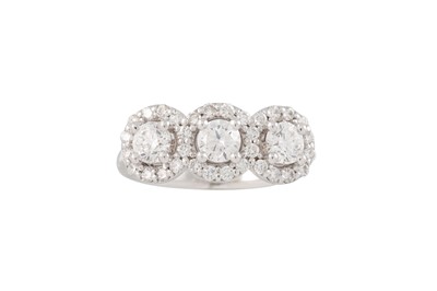 Lot 180 - A DIAMOND TRIPLE CLUSTER RING, the three round...
