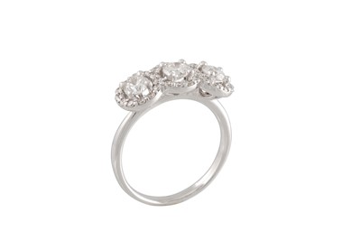 Lot 180 - A DIAMOND TRIPLE CLUSTER RING, the three round...