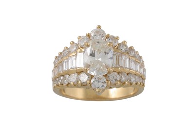 Lot 351 - A DIAMOND CLUSTER RING, the central oval stone...