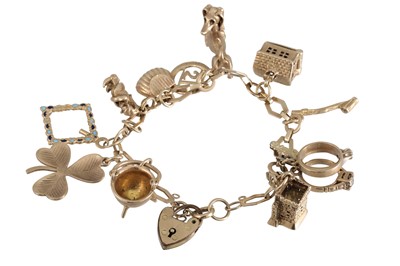 Lot 408 - A 9CT GOLD CHARM BRACELET, with various charms...