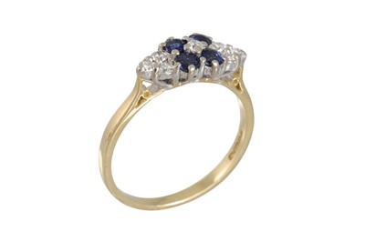 Lot 244 - A DIAMOND AND SAPPHIRE RING, set with four...