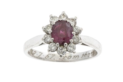 Lot 211 - A DIAMOND AND RUBY OVAL CLUSTER RING, mounted...