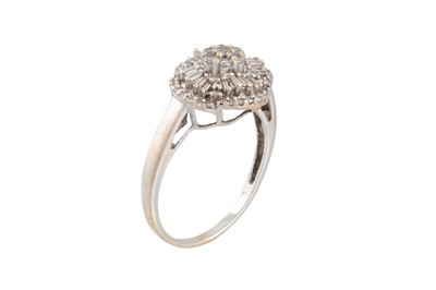 Lot 283 - A DIAMOND CLUSTER DRESS RING, set with round...