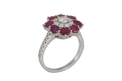 Lot 284 - A RUBY AND DIAMOND CLUSTER RING, daisy form,...