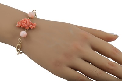 Lot 319 - A CORAL AND GOLD BRACELET, the central rose...