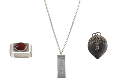 Lot 253 - A SILVER INGOT, together with a carnelian ring...