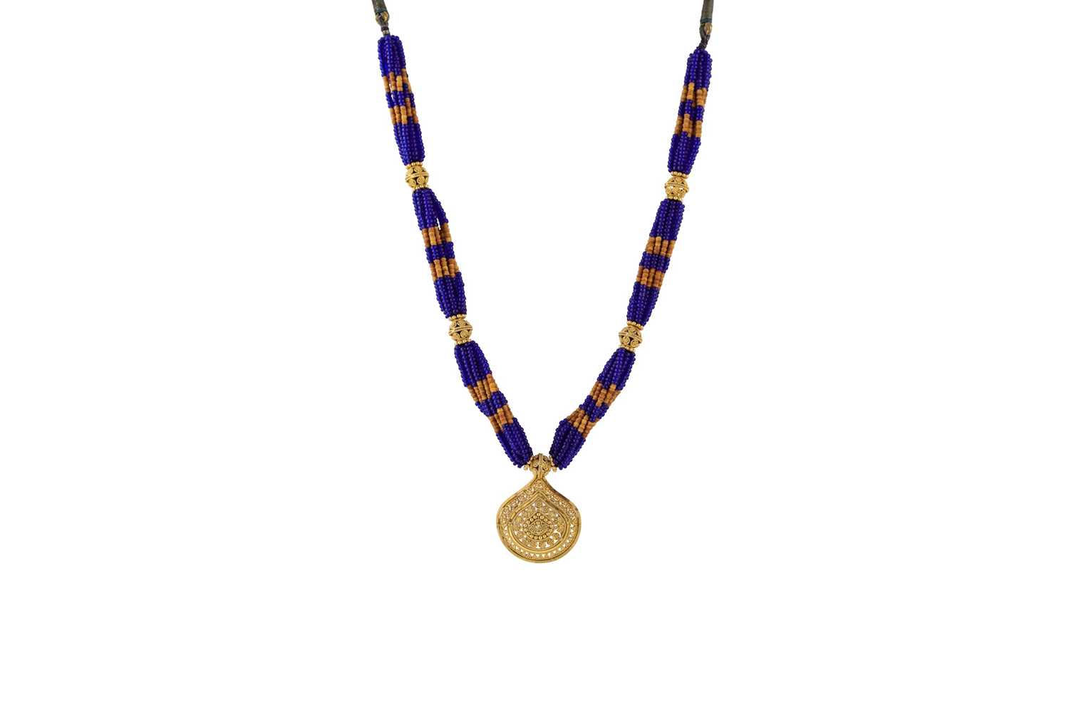 Lot 25 - A 22CT GOLD PENDANT, on a beaded necklace