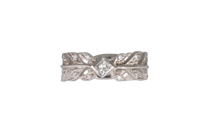 Lot 312 - A DIAMOND BAND RING, in platinum stamped 900....