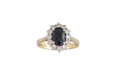 Lot 111 - A DIAMOND AND SAPPHIRE CLUSTER RING, in oval...
