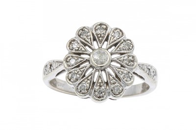 Lot 246 - A DIAMOND SET FLOWER CLUSTER RING, mounted in...