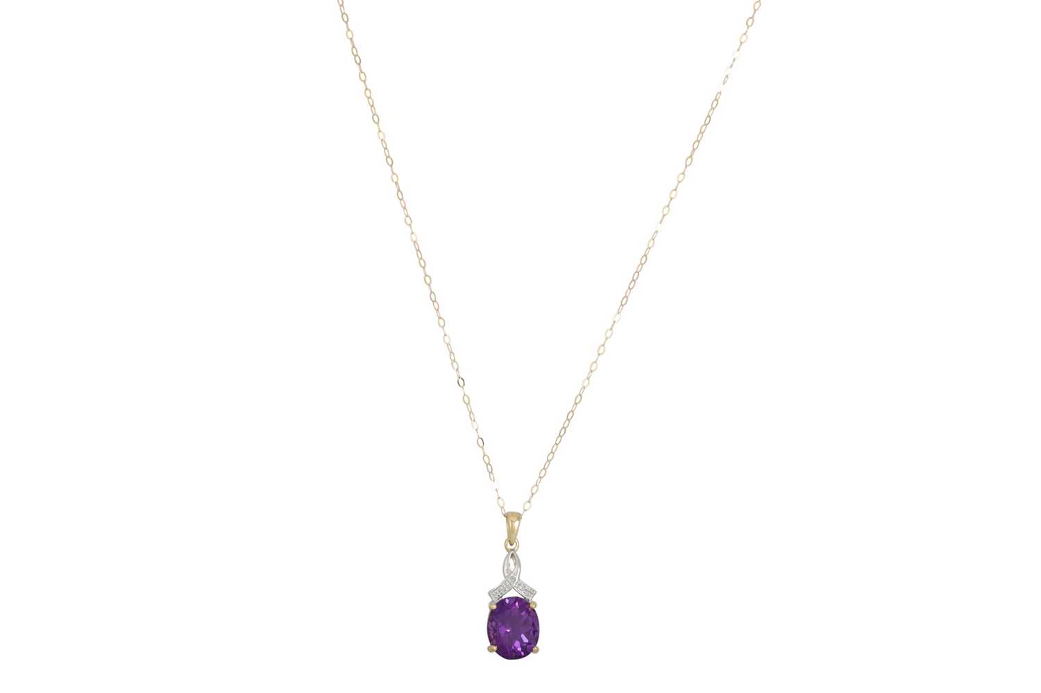 Lot 44 - A DIAMOND AND AMETHYST PENDANT, the oval...