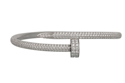 Lot 138 - A DIAMOND SET HINGED BANGLE, in the form of a...