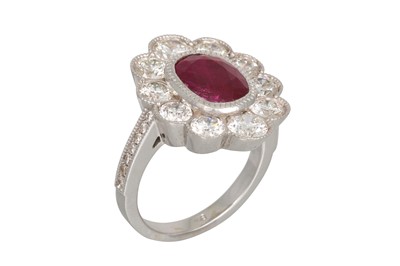 Lot 220 - A RUBY AND DIAMOND CLUSTER RING, the oval ruby...