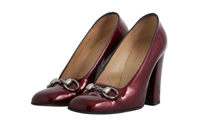 Lot 204 - A PAIR OF GUCCI BURGUNDY PATENT LEATHER HEELS,...