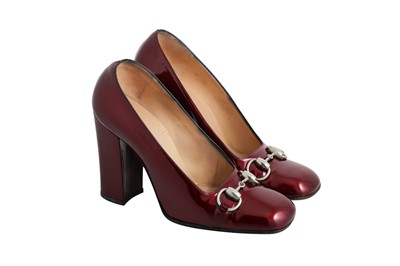 Lot 204 - A PAIR OF GUCCI BURGUNDY PATENT LEATHER HEELS,...