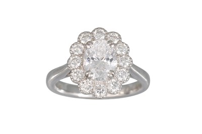 Lot 363 - A DIAMOND CLUSTER RING, the oval diamond to a...