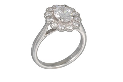 Lot 221 - A DIAMOND CLUSTER RING, the oval diamond to a...