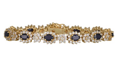Lot 360 - A DIAMOND AND SAPPHIRE BRACELET, of cluster...