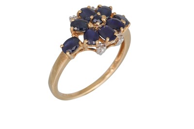 Lot 58 - A SAPPHIRE AND DIAMOND CLUSTER RING, set with...