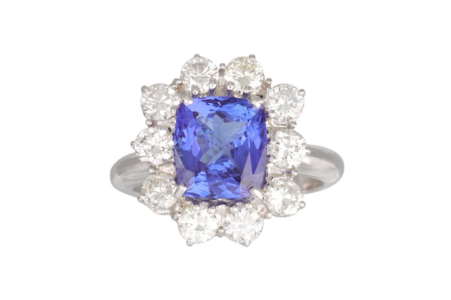 Lot 167 - A TANZANITE AND DIAMOND CLUSTER RING, the trap...
