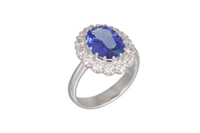 Lot 168 - A SAPPHIRE AND DIAMOND CLUSTER RING, the oval...