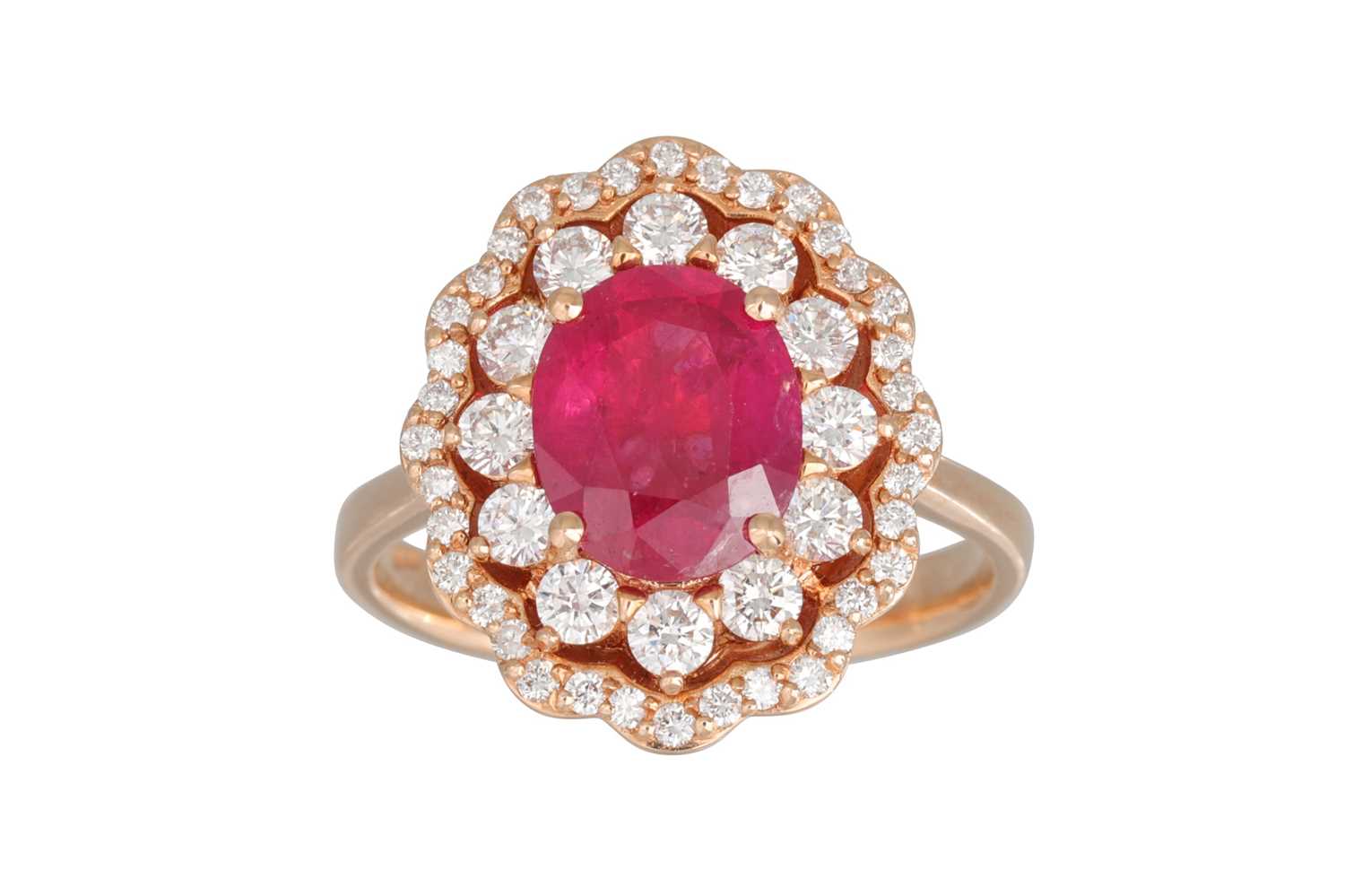Lot 228 - A DIAMOND AND RUBY CLUSTER RING, the oval ruby...